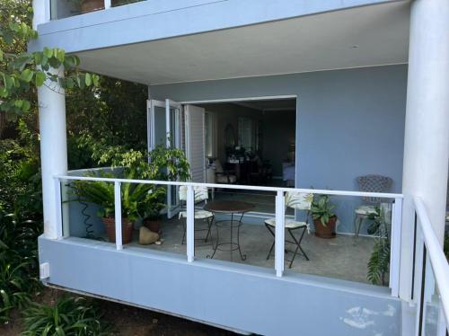 a balcony with plants and a table and chairs at Bo-Yoga in Ramsgate