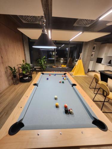 a pool table with balls on it in a room at WARSZAWA CENTRAL HOUSE - Studios in Warsaw with Private Jacuzzi, full access to Sauna, Gym and Billards - Studia z prywatnym Jacuzzi oraz dostępem do sauny, siłowni i bilarda in Warsaw