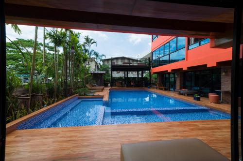 a swimming pool in the middle of a house at Thongtara House Boutique Srinakarin in Bangkok