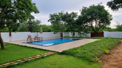 a swimming pool in the backyard of a house at Kirinda Heaven - Yala in Kirinda