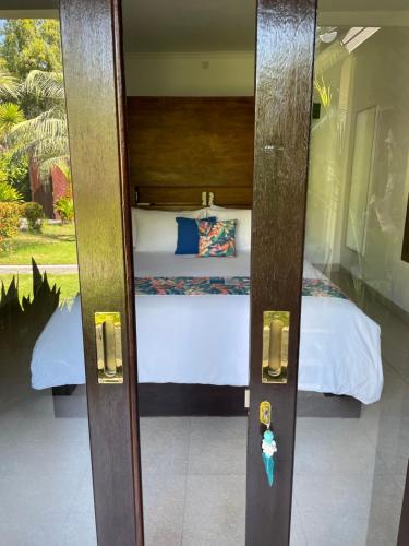 a door to a bedroom with a bed at Kaien Villas Gili Air in Gili Air