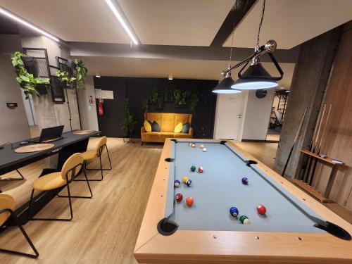 a pool table in the middle of a room at WARSZAWA CENTRAL HOUSE - Studios in Warsaw with Private Jacuzzi, full access to Sauna, Gym and Billards - Studia z prywatnym Jacuzzi oraz dostępem do sauny, siłowni i bilarda in Warsaw