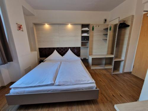a bedroom with a large bed and a closet at Center Hotel Essen in Essen