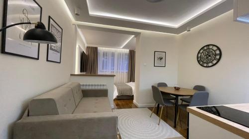 a living room with a couch and a table at Luka Luxury Suite in Belgrade