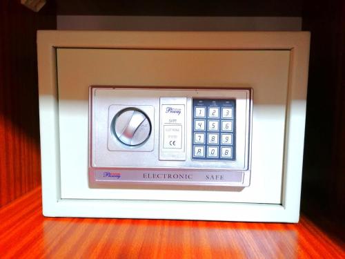a picture of a microwave in a white frame at Sand Castle Villa in Trou aux Biches
