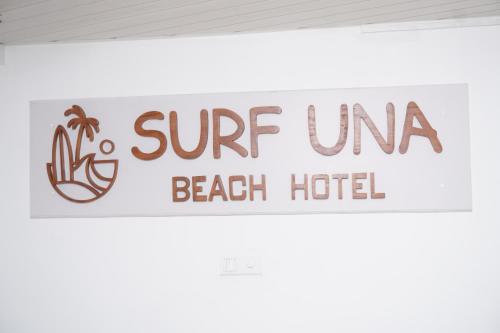 a sign that reads surf una beach hotel at SURF UNA BEACH HOTEL in Unawatuna