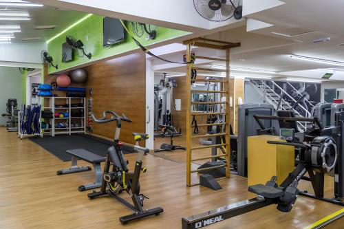 a gym with several treadmills and ellipticals at Metropolitan Flats in Curitiba