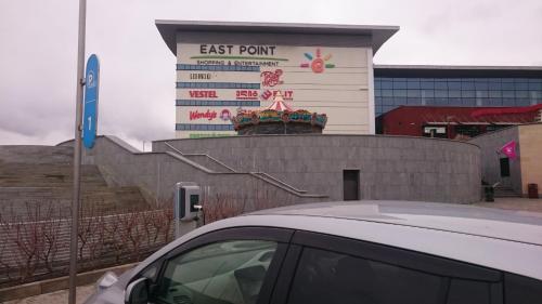 a car parked in front of a building with a sign at Love Journey Tbilisi in Tbilisi City