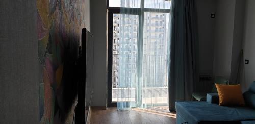 a living room with a view of a large window at Love Journey Tbilisi in Tbilisi City
