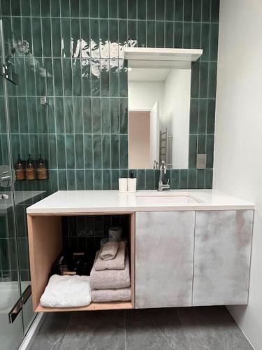 a bathroom with a sink and a mirror at New Ample and Cozy One Bedroom Apt in Brooklyn at Rem-Casa in Brooklyn