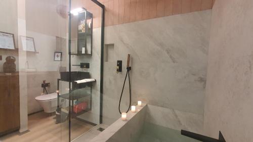 a bathroom with a shower and a tub with candles at RentAdore Retiro Studio in Madrid