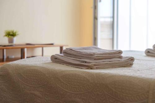 a stack of towels sitting on top of a bed at Baska Voda Apartment 7 in Baška Voda