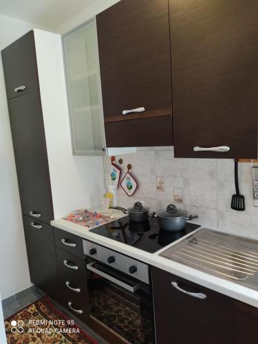 a kitchen with a stove with pots and pans on it at Appartamento centro Brusson. in Brusson