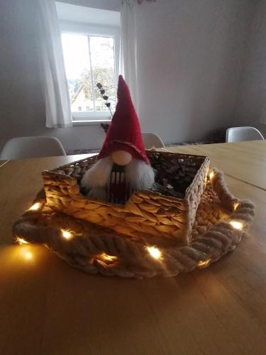 a gnome is sitting in a basket on a table at Chalupa Krkonoše in Cerny Dul