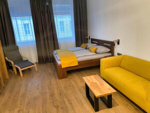 a living room with a bed and a couch at Apartment Elinel in Žilina
