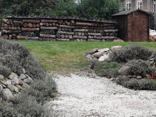 a garden with a stone wall and some bushes at Chalupa Krkonoše in Cerny Dul
