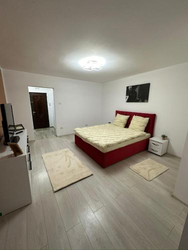 a bedroom with a bed and two rugs on the floor at Crang Luxury View in Buzău