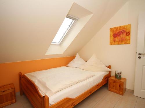 a bed in a room with a window at Appartementhaus am Kiessee, Westerholt in Westerholt