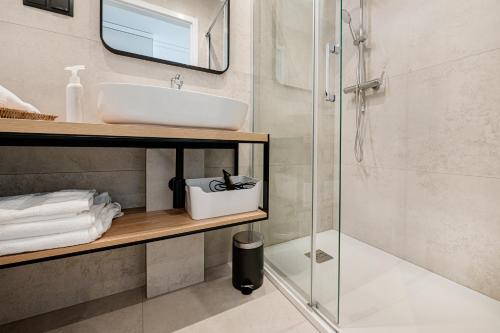 a bathroom with a sink and a shower at Chaplin Apartment in Poznań