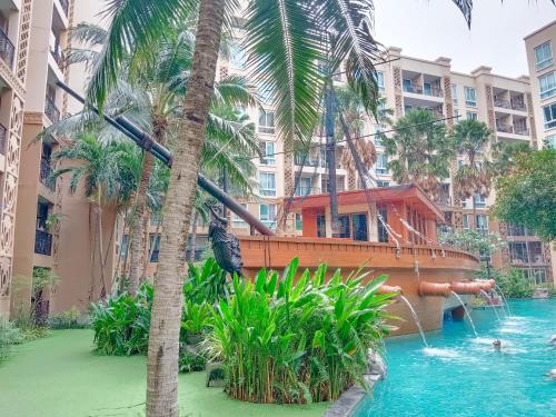 a pool at a resort with a water slide at Atlantis Condo Resort in Jomtien Beach