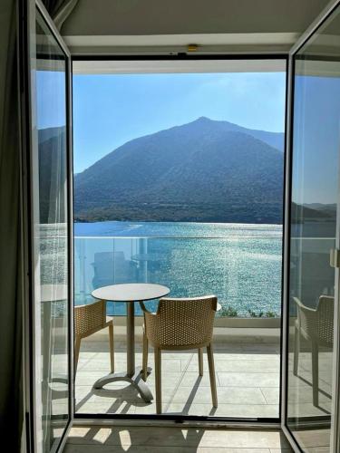 a table and chairs on a balcony with a view of the water at Blue Bay Lifestyle - ex Bali Blue Bay in Balíon