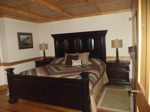 a bedroom with a large wooden bed with two night stands at The Inn & Spa at Intercourse Village in Intercourse
