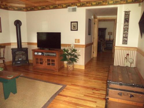 a living room with a flat screen tv and a wood stove at The Inn & Spa at Intercourse Village in Intercourse