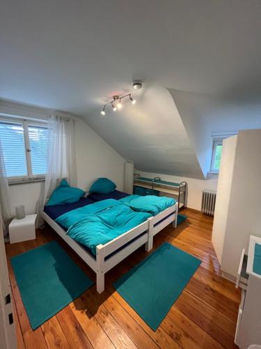 a bedroom with a bed with blue sheets and blue pillows at Haus am Bach in Schwäbisch Gmünd