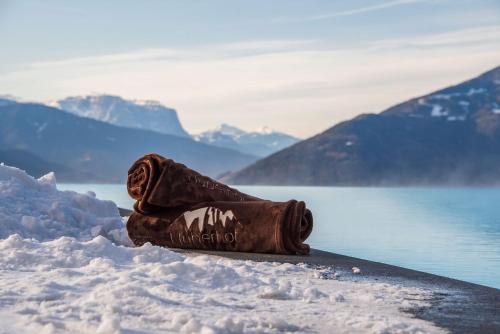 a chocolate bag sitting in the snow on a snowboard at Panoramahotel Huberhof in Maranza