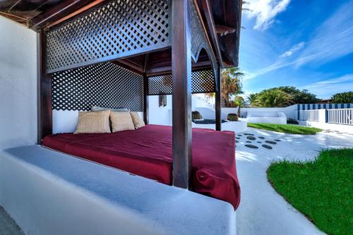 a bed is sitting on a patio at Villa Picasso private Pool in Playa Blanca