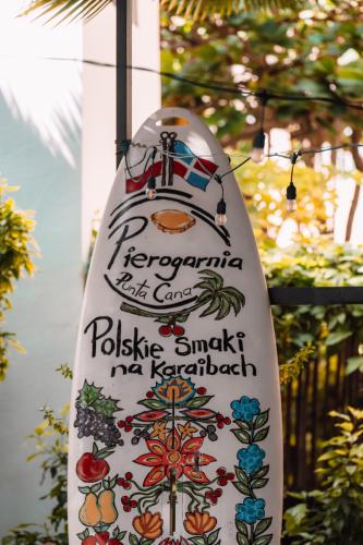 a sign for a restaurant on a pole at Riviera Punta Cana Eco Travelers in Punta Cana