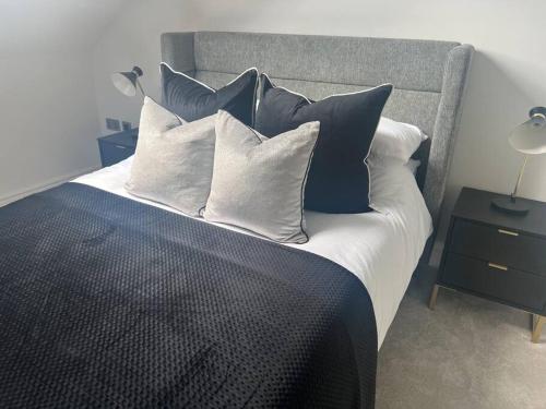 a bedroom with a bed with blue and white pillows at 2 Bedroomed apt by Sefton Park and Spire Hospital in Liverpool