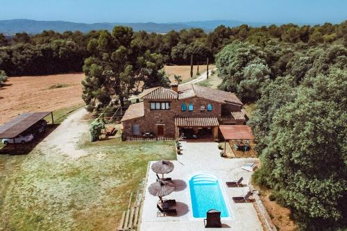 an aerial view of a house with a swimming pool at Mas Valoria in Peratallada