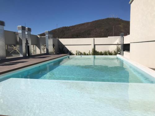 a swimming pool in the middle of a building at AIRES VERDES PREMIUM in Salta