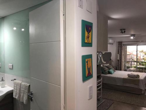 a bathroom with a bedroom with a bed and a sink at AIRES VERDES PREMIUM in Salta