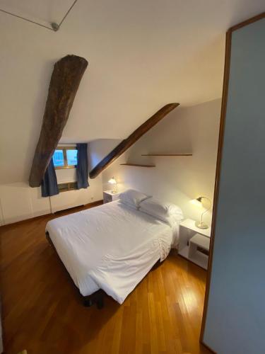 a bedroom with a white bed and a staircase at Artua'&Solferino in Turin