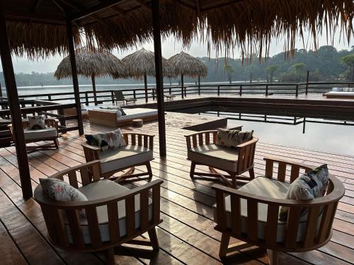 a resort deck with chairs and a swimming pool at Juma Amazon Lodge in Autazes