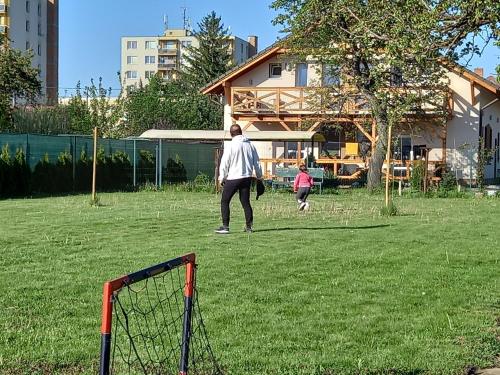 a man and a child playing with a frisbee at Flower Bike in Štúrovo