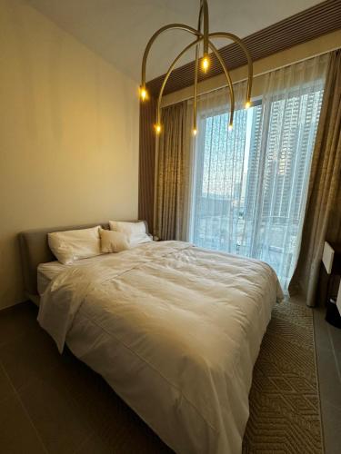 a large bed in a bedroom with a large window at Forte Downtown Dubai in Dubai