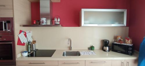 a kitchen with a sink and a microwave at Twin Room in shared Apartment in Cee