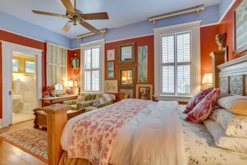 a bedroom with red walls and a large bed at Private Pool and Backyard Lavish New Orleans Haven! in New Orleans