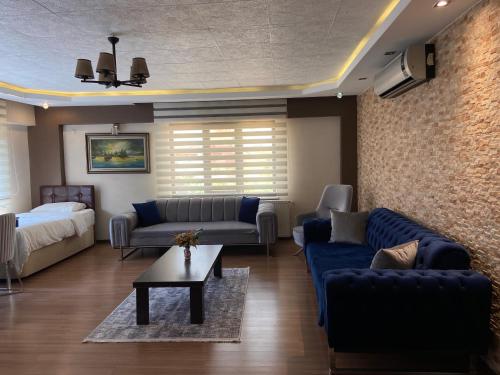a living room with blue furniture and a brick wall at Araz Apart in Bursa