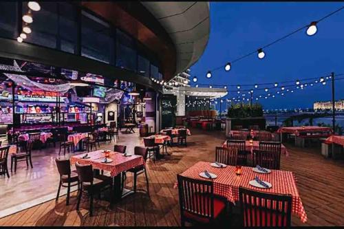 a restaurant with tables and chairs and a bar at Sunshine in Ras al Khaimah
