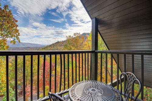 a table and chairs on a balcony with a view at Above and Beyond Pigeon Forge Cabin with Prime Views! in Pigeon Forge