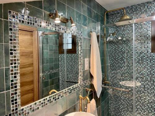 a bathroom with a sink and a mirror at Casina Marqués in Cudillero