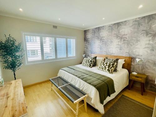 a bedroom with a large bed and a window at Perfect location #19, Mouille Point in Cape Town