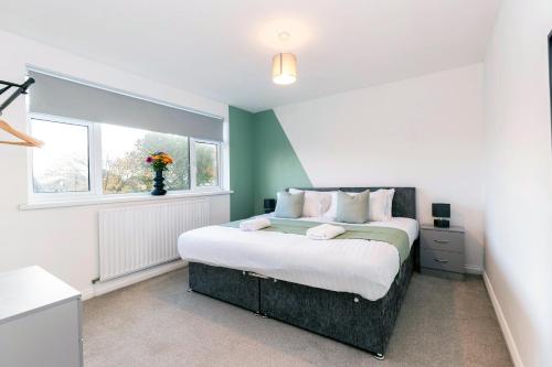 a bedroom with a large bed and a window at Cherry House in Durham