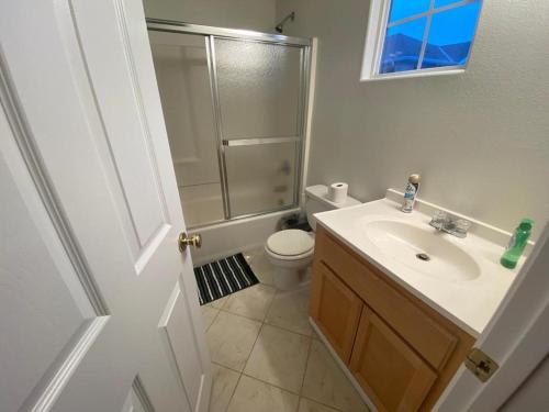 a bathroom with a toilet and a sink and a shower at Zen Home in Santa Ana