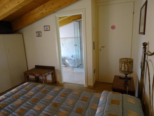 a bedroom with a bed and a bathroom with a tub at B&B Spring in Perugia
