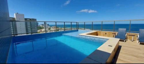 a swimming pool on the roof of a building at Vista mar no costa azul in Salvador